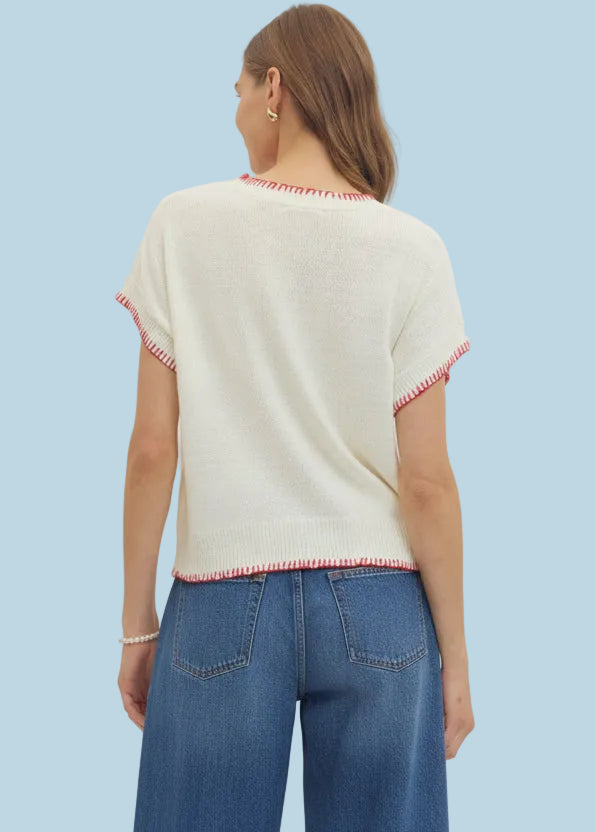 Woman wearing a cream jeans pink striped pants on a white background