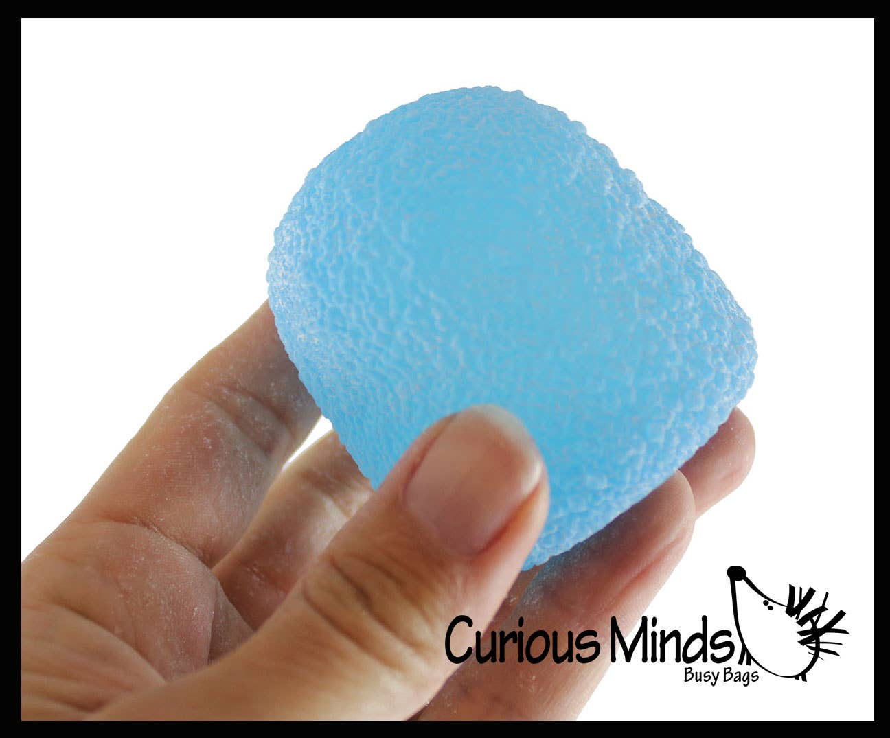Blue textured ball held in a hand with 'Curious Minds' branding.