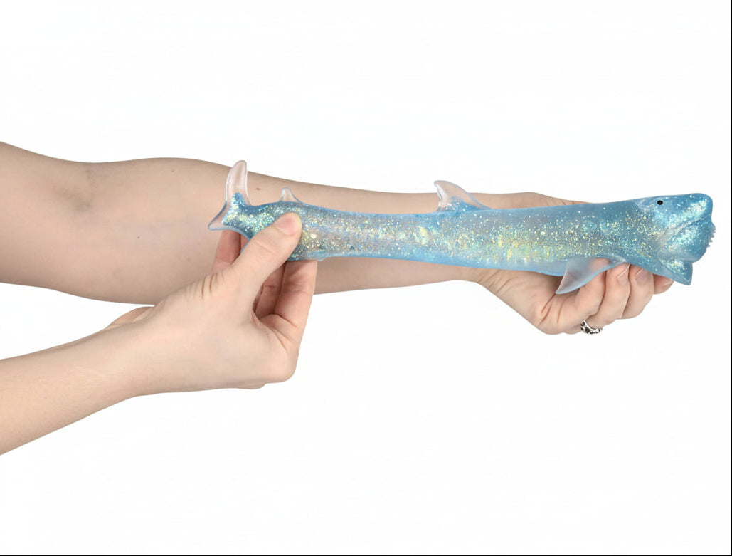 Hand holding a glittery blue and silver object against a white background, with 'Curious Minds' branding.