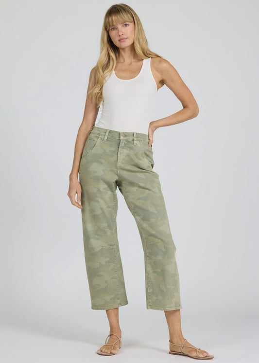 Woman wearing a white tank top and green camouflage pants on a white background